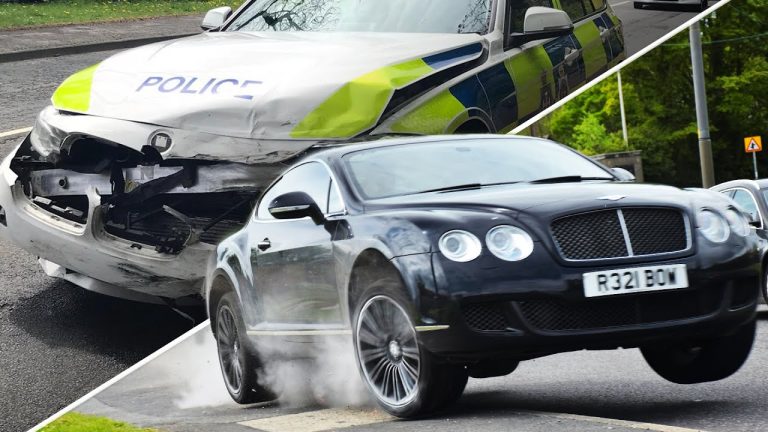 Black car speeds past damaged police vehicle.