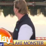 Reporter fishing in lake during news segment.