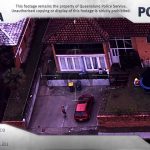 Aerial view of house, car, and garden scene.