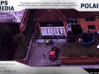 Aerial view of house, car, and garden scene.