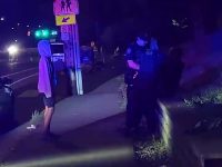 Night street scene with police interaction