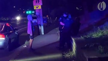 Night street scene with police interaction