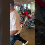 People in store with strollers and shopping bags.