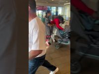 People in store with strollers and shopping bags.