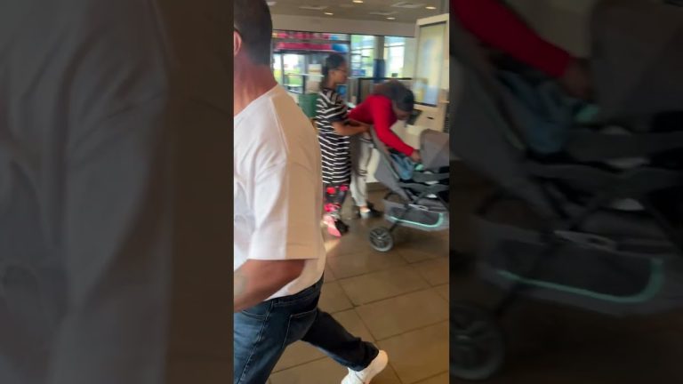 People in store with strollers and shopping bags.