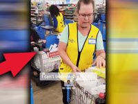 Store employee at checkout counter with cart.