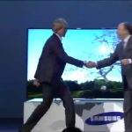 Two executives shaking hands at Samsung event.