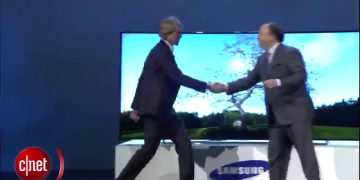 Two executives shaking hands at Samsung event.