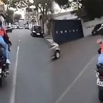 Delivery riders driving on urban road.