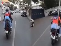 Delivery riders driving on urban road.