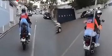 Delivery riders driving on urban road.