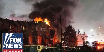 Firefighters battling roof fire at night