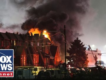 Firefighters battling roof fire at night