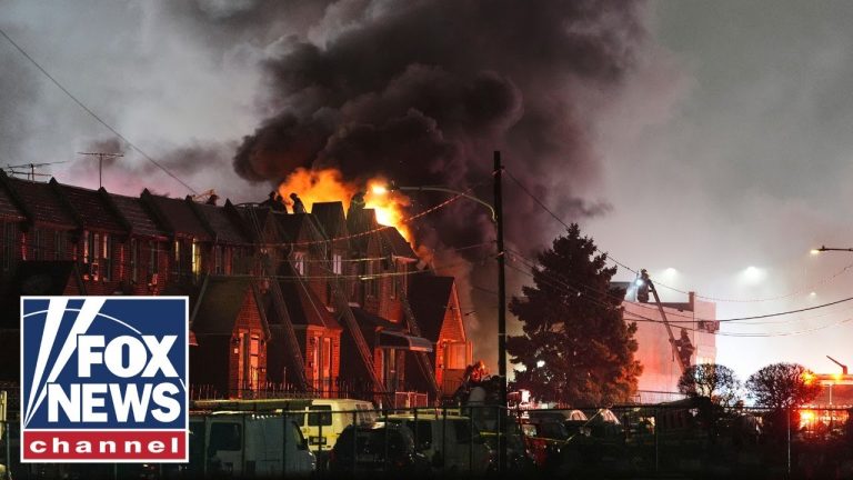 Firefighters battling roof fire at night