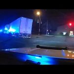 Truck with police lights at night intersection