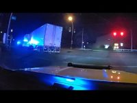 Truck with police lights at night intersection