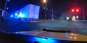 Truck with police lights at night intersection
