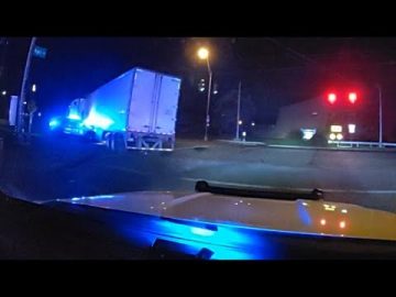 Truck with police lights at night intersection