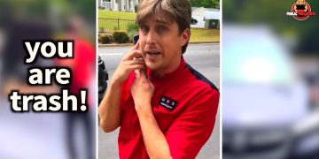Person in red shirt looking surprised outdoors.