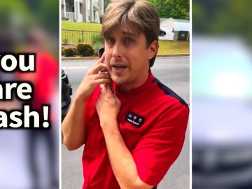Person in red shirt looking surprised outdoors.