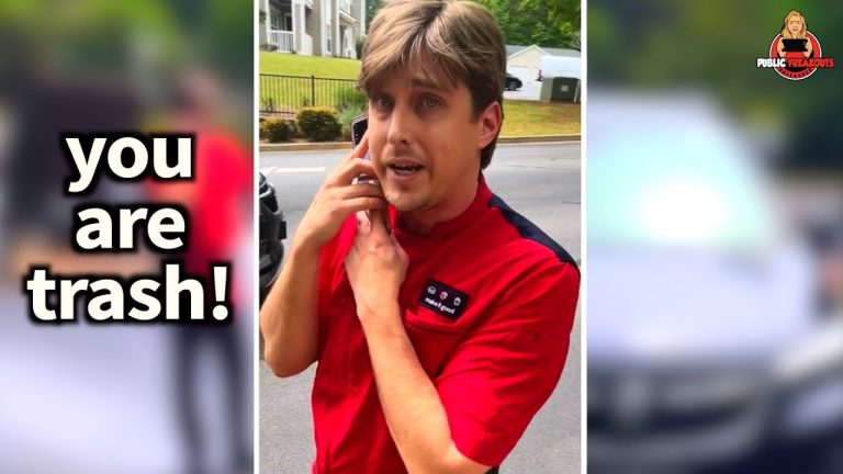 Person in red shirt looking surprised outdoors.