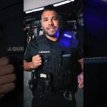 Person wearing tactical gear with equipment.