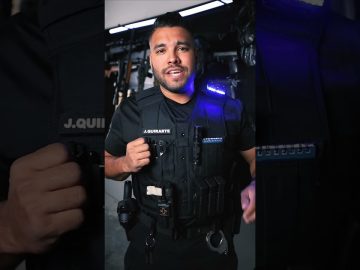 Person wearing tactical gear with equipment.