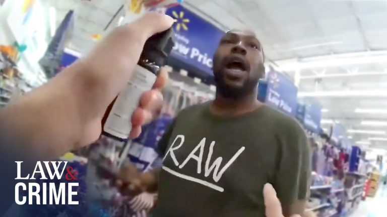 Person in store with spray can, Walmart signs visible.