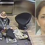 Surveillance image of woman seated in office.