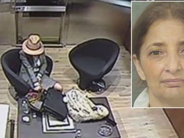 Surveillance image of woman seated in office.