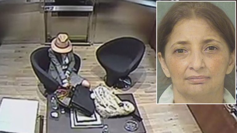 Surveillance image of woman seated in office.