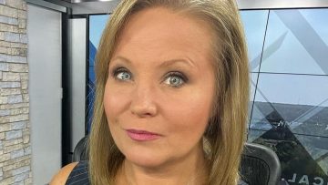 Person in news studio setting, close-up view.