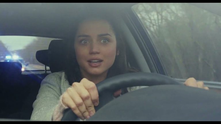 Woman looking surprised while driving a car.