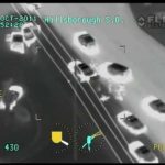 Aerial infrared view of cars on a highway.
