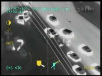 Aerial infrared view of cars on a highway.