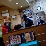 Subway employees interacting with customers at the counter.