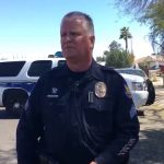Police officer at scene with patrol cars