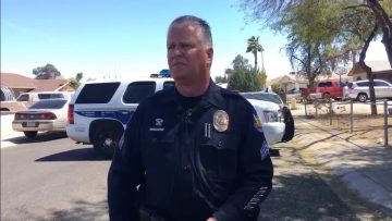 Police officer at scene with patrol cars