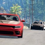 Red car chased by two police cars on road.