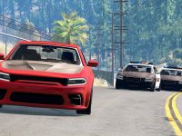 Red car chased by two police cars on road.