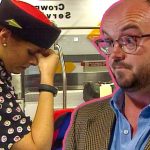 Airport worker looking stressed at counter