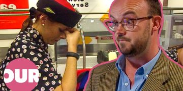 Airport worker looking stressed at counter