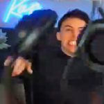 Person excitedly holding VR headset indoors.