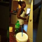 Woman talking in kitchen holding door.