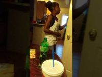 Woman talking in kitchen holding door.