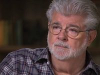 Man with glasses and gray beard in checkered shirt.