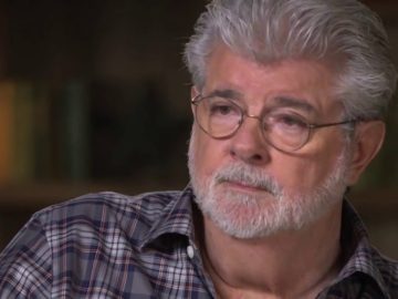 Man with glasses and gray beard in checkered shirt.