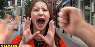 Woman shouting on city street with blurred fists.