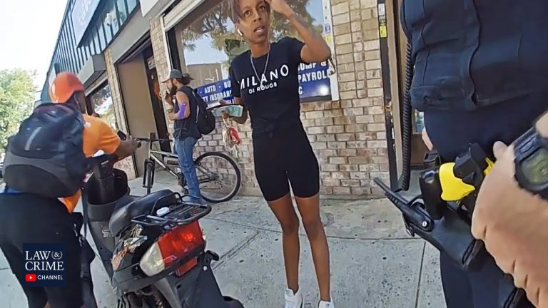 People talking and standing near a scooter on sidewalk.