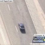 Car speeding on highway during news broadcast